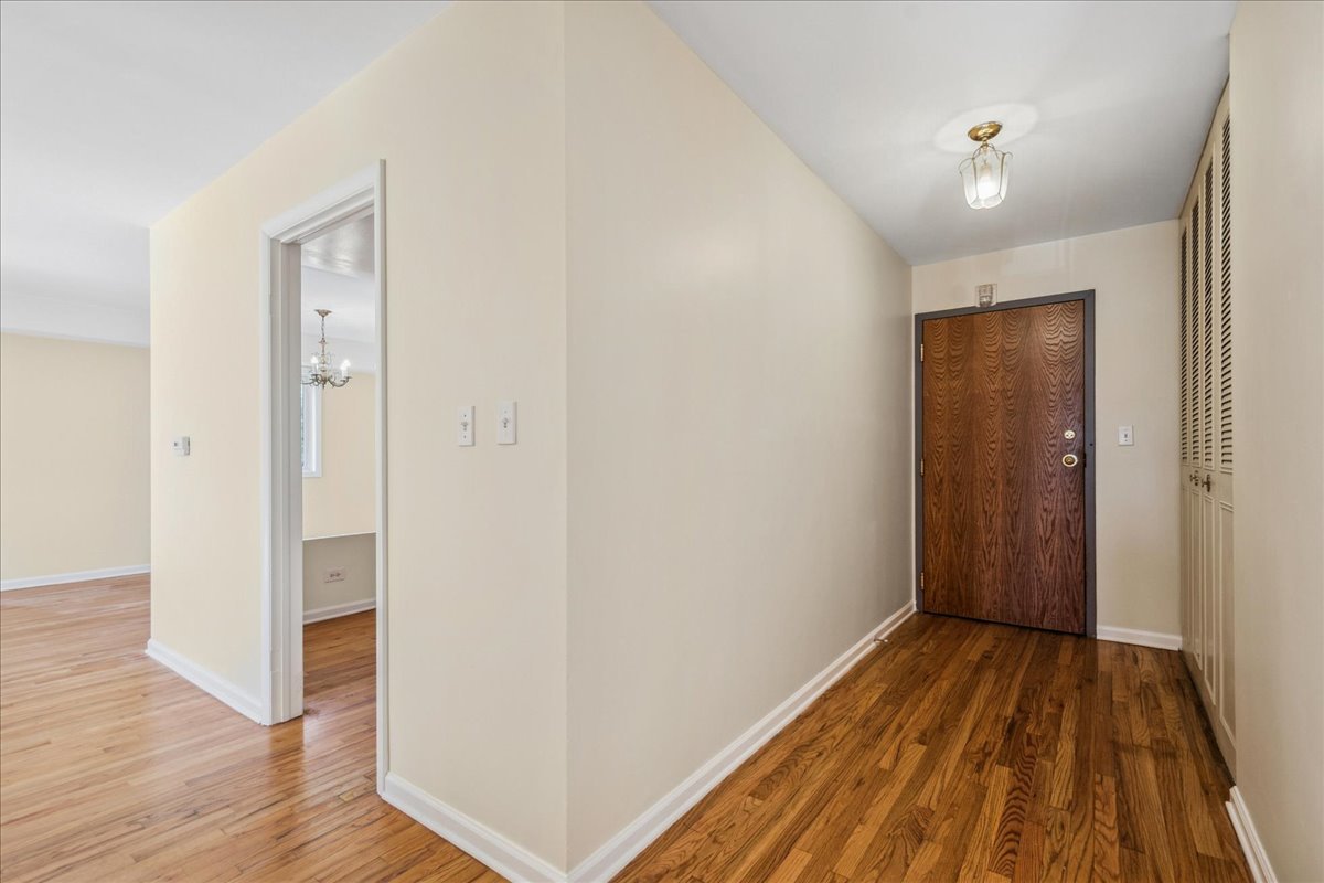 828 Oakton Street, Unit 3F Evanston, IL 60202 - Photo 3 of 21 a view of a hallway with wooden floor