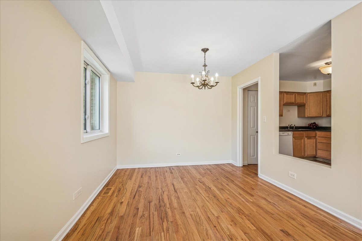 828 Oakton Street, Unit 3F Evanston, IL 60202 - Photo 8 of 21 a view of a room with wooden floor and staircase