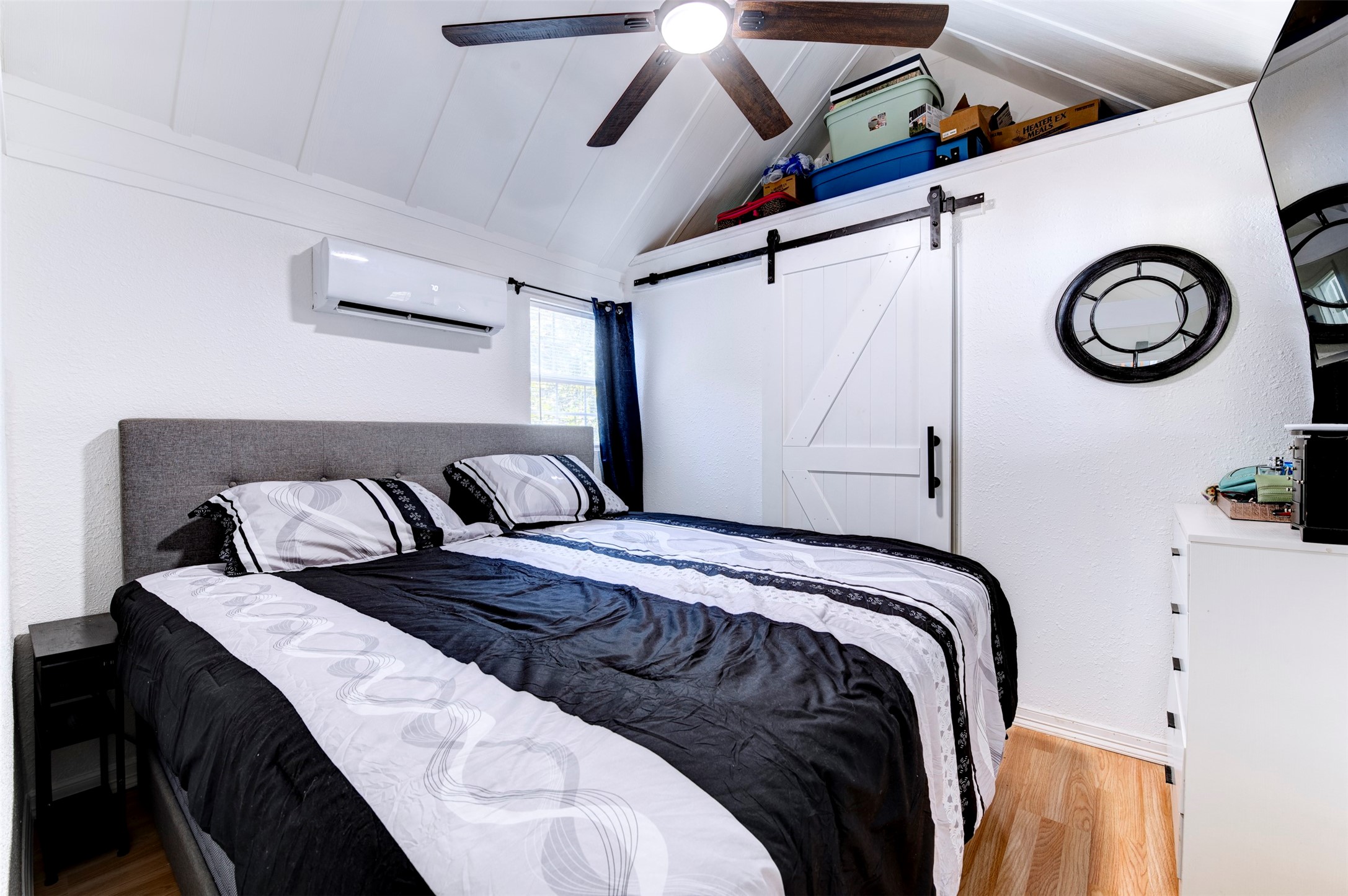 664 Jensen Drive Cleveland, TX 77327 - Photo 12 of 36 a bedroom with a bed and a chandelier