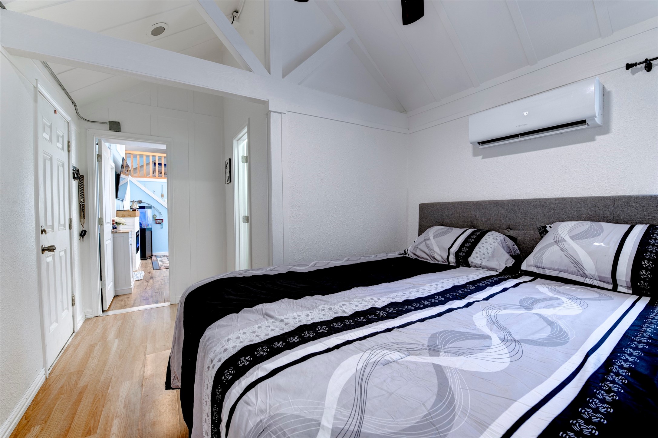 664 Jensen Drive Cleveland, TX 77327 - Photo 13 of 36 a bedroom with a bed and wooden floor