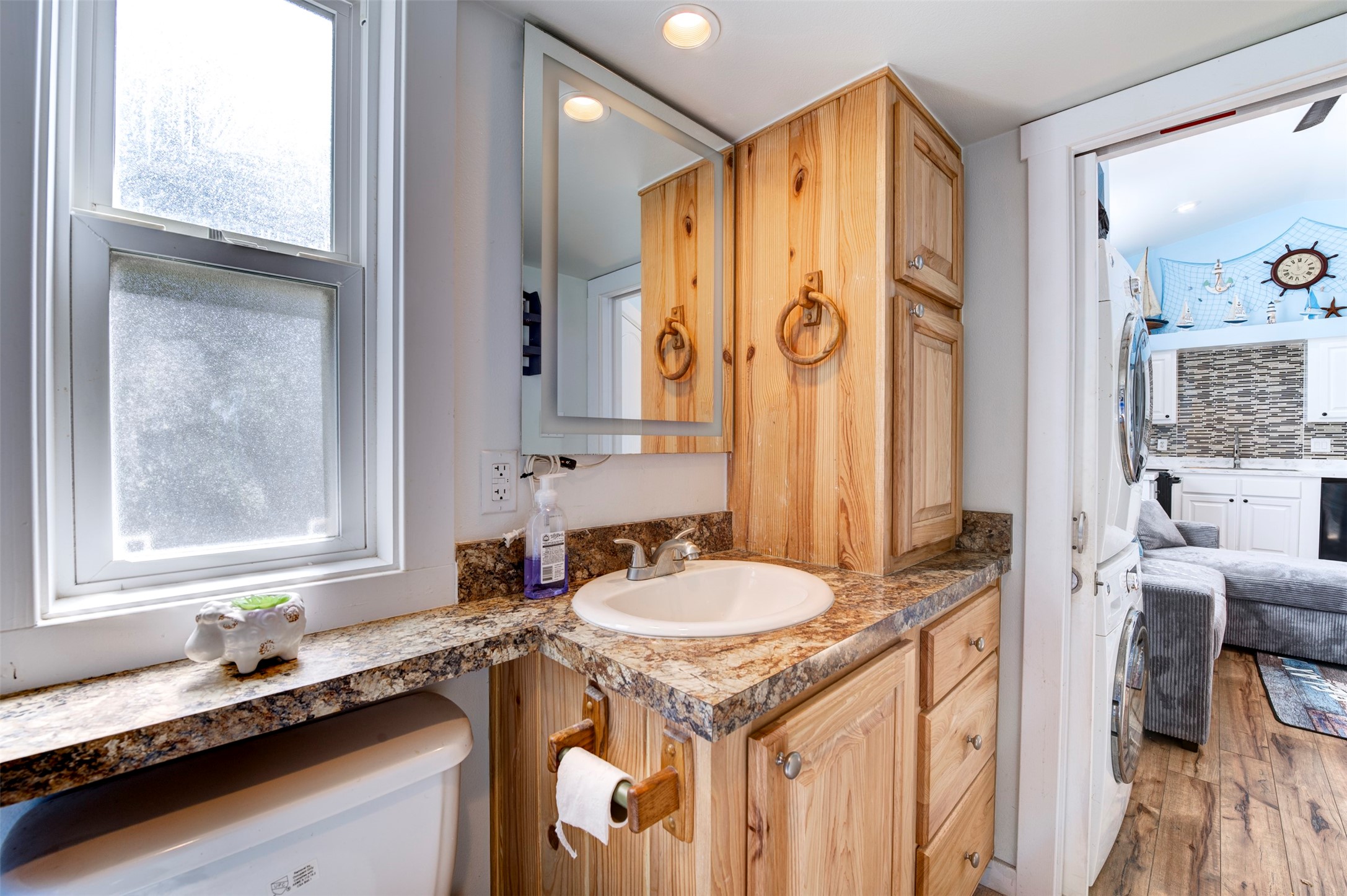 664 Jensen Drive Cleveland, TX 77327 - Photo 18 of 36 a bathroom with a granite countertop sink and a mirror
