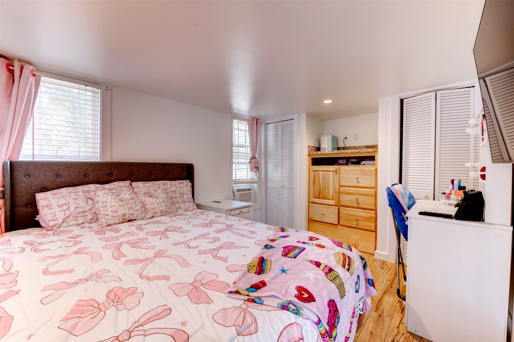 664 Jensen Drive Cleveland, TX 77327 - Photo 19 of 36 a bedroom with a large bed and a flat tv screen