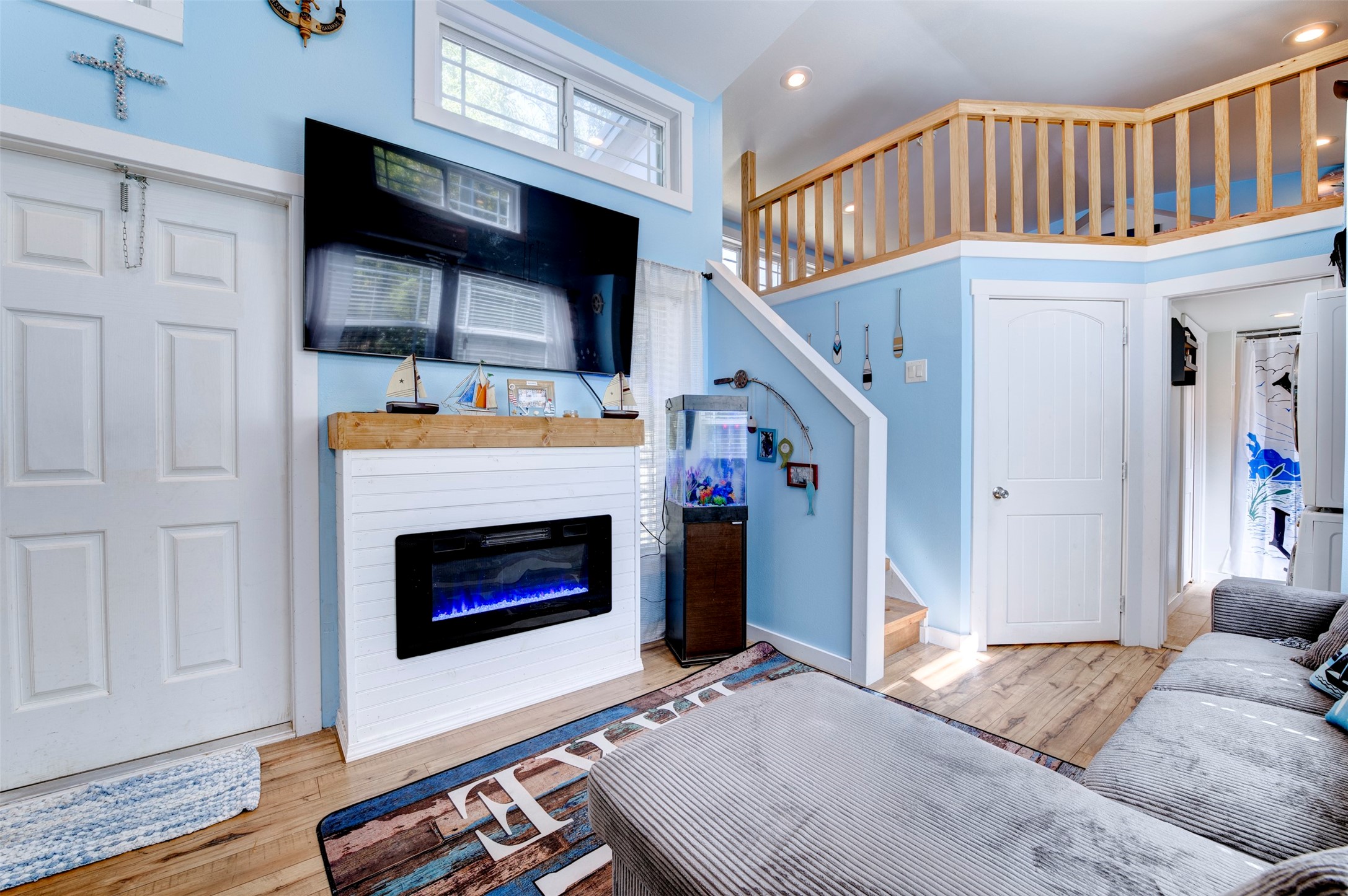 664 Jensen Drive Cleveland, TX 77327 - Photo 2 of 36 a living room with furniture flat screen tv and a fireplace