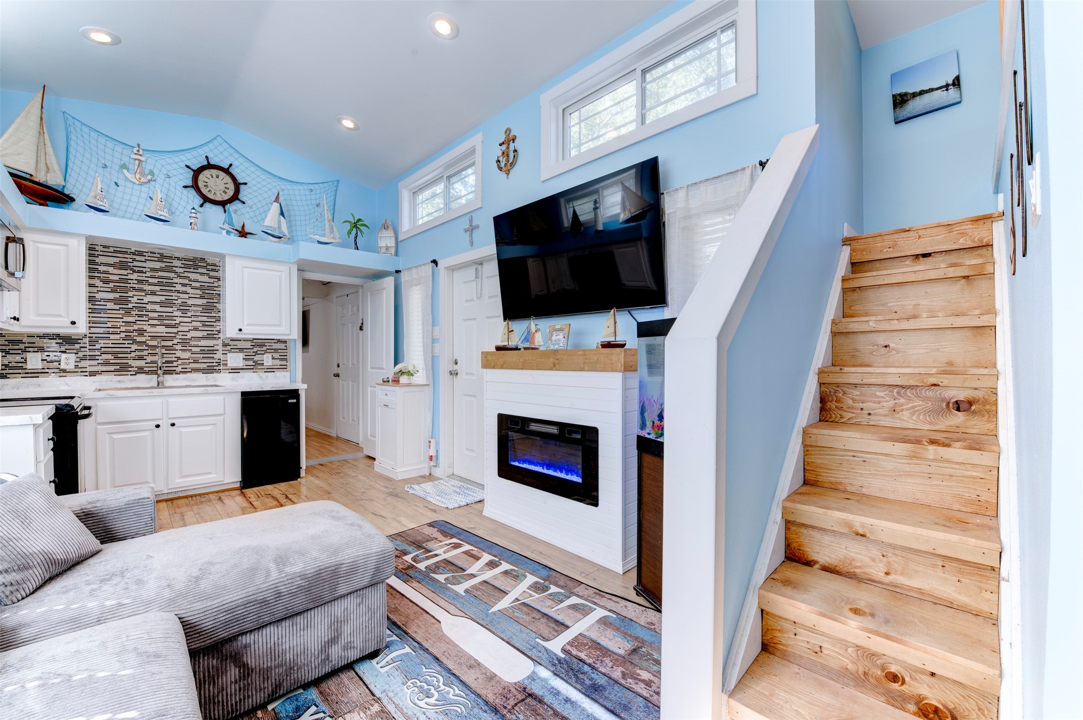 664 Jensen Drive Cleveland, TX 77327 - Photo 4 of 36 a living room with furniture a flat screen tv and a fireplace