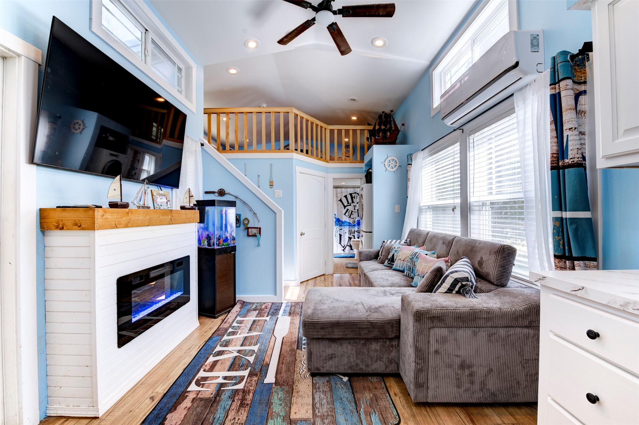 664 Jensen Drive Cleveland, TX 77327 - Photo 6 of 36 a living room with furniture a flat screen tv and a fireplace