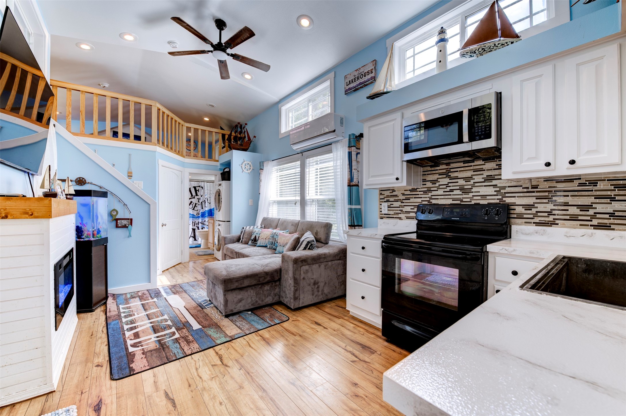 664 Jensen Drive Cleveland, TX 77327 - Photo 7 of 36 a kitchen with stainless steel appliances kitchen island granite countertop a stove top oven a sink a dining table and chairs with wooden floor