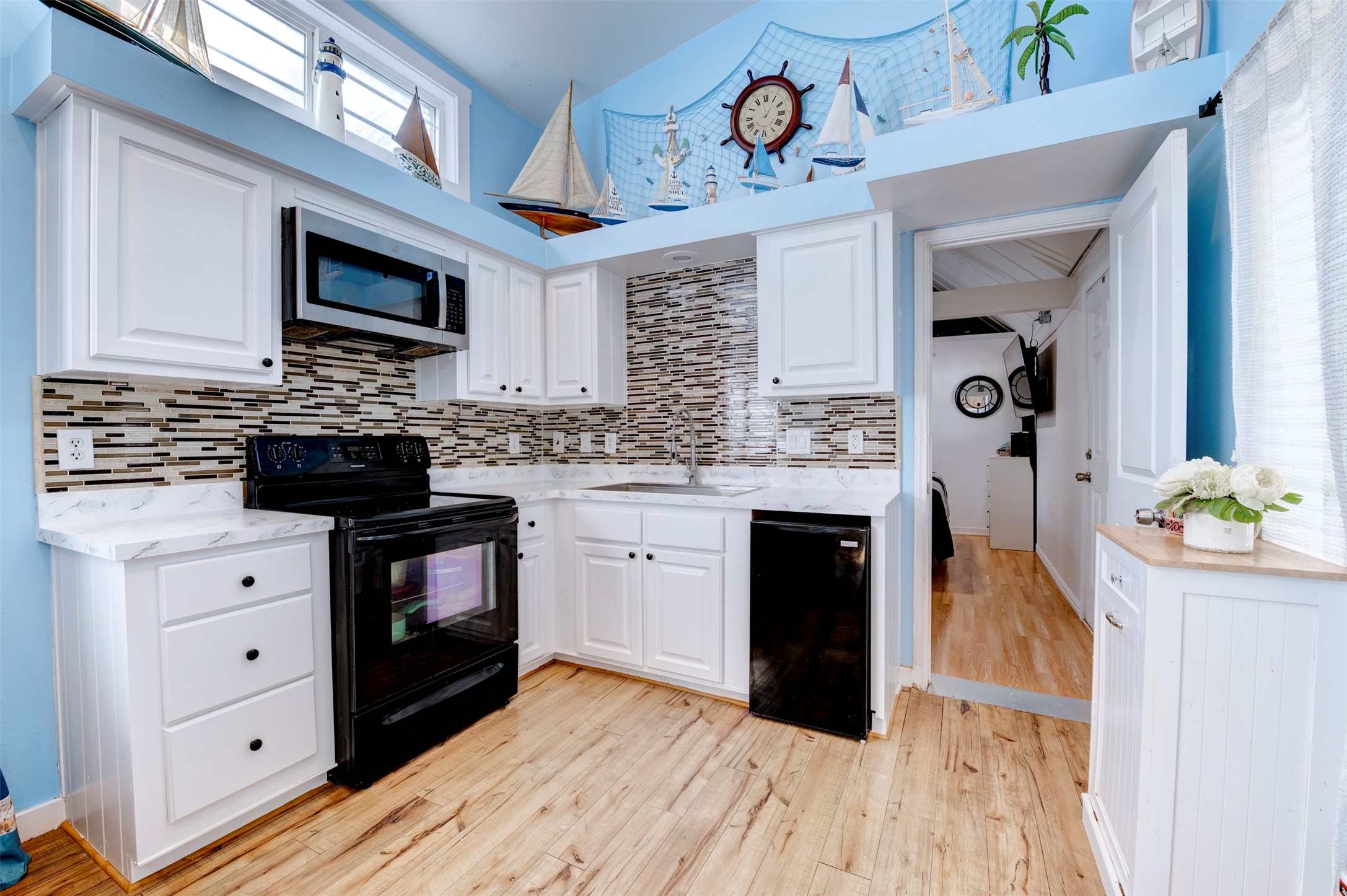 664 Jensen Drive Cleveland, TX 77327 - Photo 10 of 36 a kitchen with a stove window and cabinets