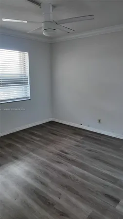 an empty room with wooden floor