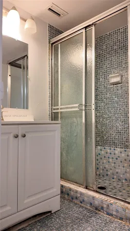 a white toilet sitting next to a shower