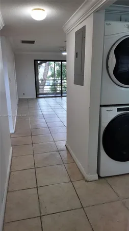 a view of a hallway with washer and dryer