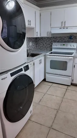 a kitchen with a stove and a sink