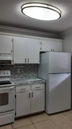a kitchen with cabinets appliances and cabinets