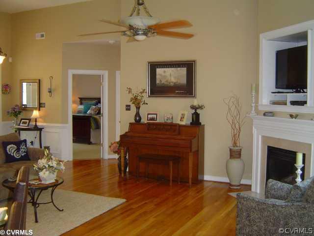 13906 North Point Road Midlothian, VA 23112 - Photo 3 of 12 a living room with furniture a fireplace and a flat screen tv