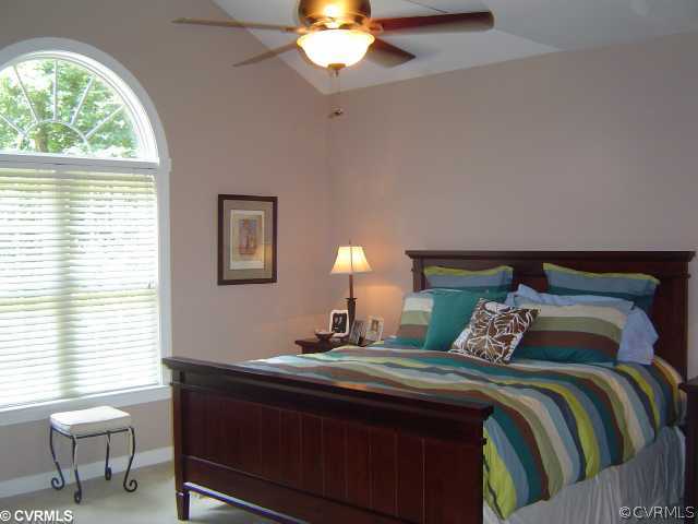13906 North Point Road Midlothian, VA 23112 - Photo 7 of 12 a bedroom with a bed and a chandelier