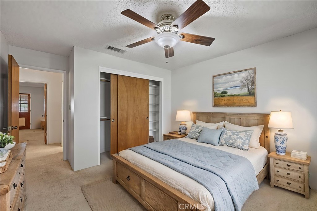 2065 Jenkins Road Bakersfield, CA 93314 - Photo 28 of 59 a bedroom with a bed and a chandelier