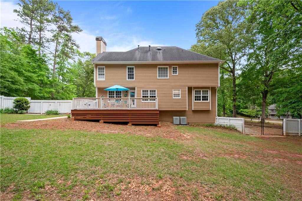 405 Ridgemont Drive Fayetteville, GA 30215 - Photo 37 of 43 a view of a house with backyard porch and sitting area