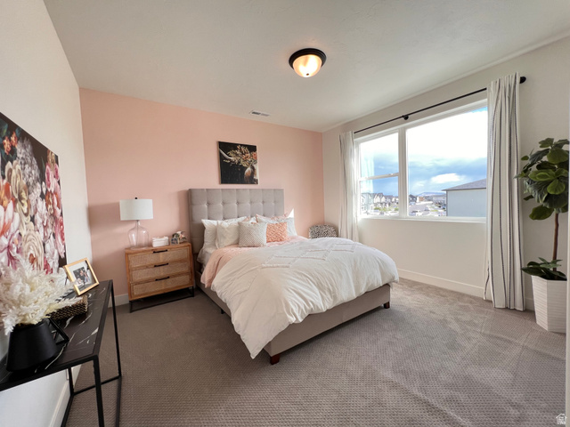 1951 2900 West Provo, UT 84601 - Photo 17 of 21 Bedroom featuring a large window, neutral carpeting, and a built-in flush mount ceiling light