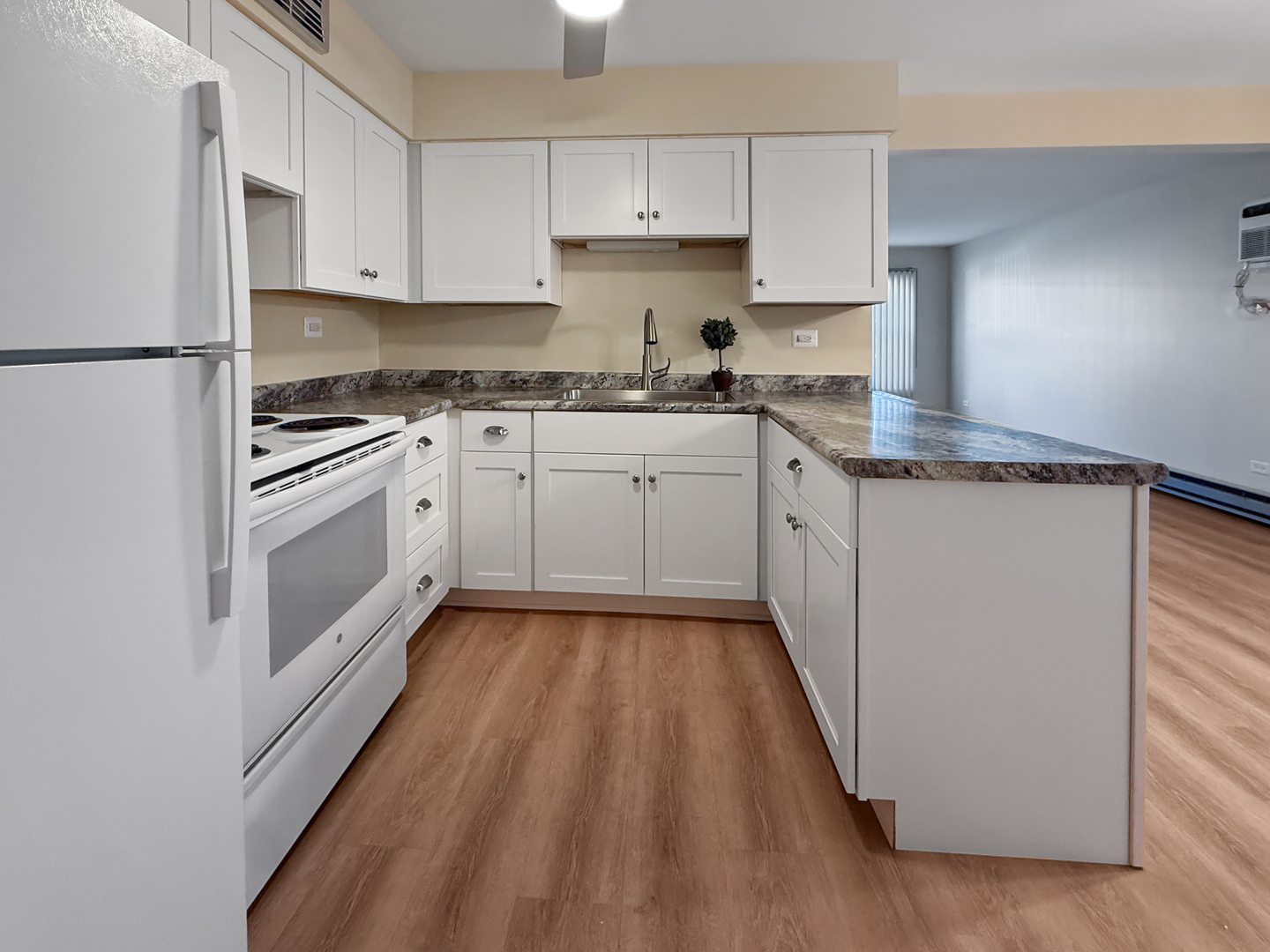 2025 Maple Road, Unit 1E Homewood, IL 60430 - Photo 5 of 12 a kitchen with granite countertop white cabinets and white appliances