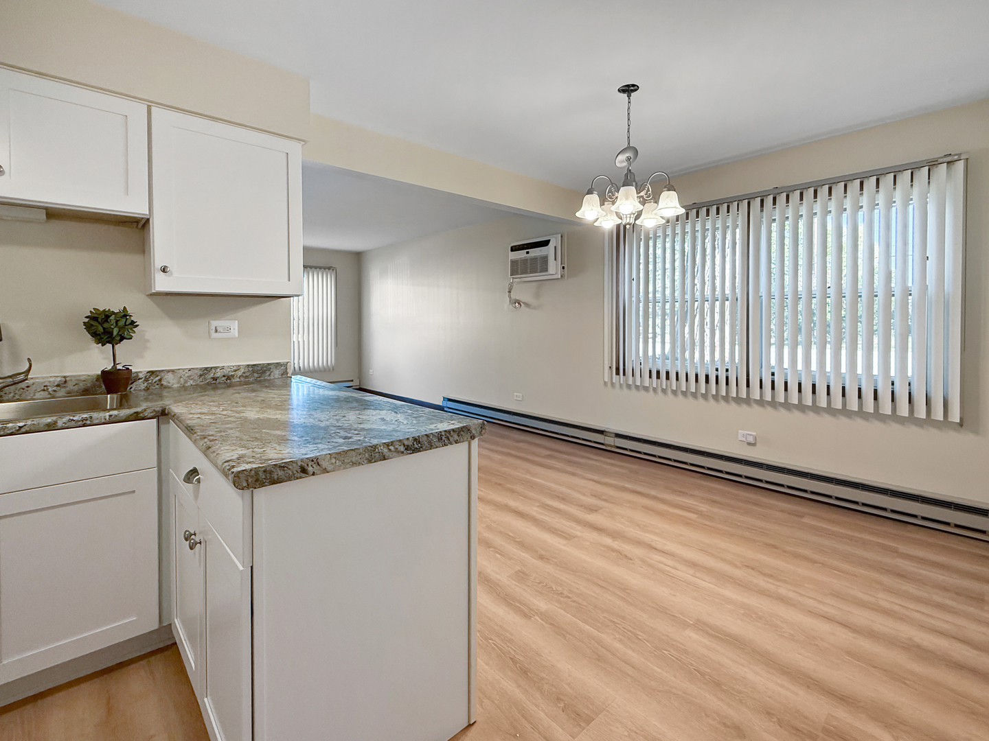 2025 Maple Road, Unit 1E Homewood, IL 60430 - Photo 6 of 12 a kitchen with granite countertop a stove and a wooden floor