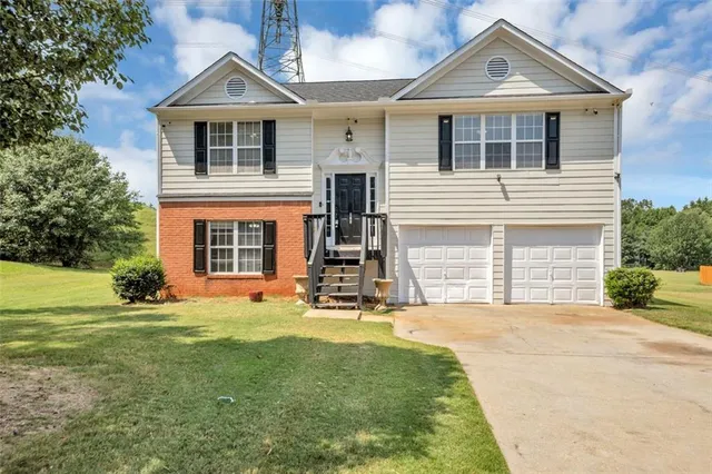 a front view of a house with a yard