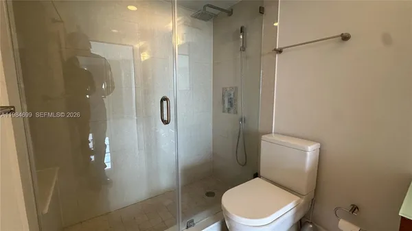a white toilet sitting next to a bathroom sink