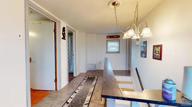 a view of a dining room with furniture wooden floor and a chandelier