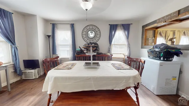 a view of a dining room with furniture window and wooden floor
