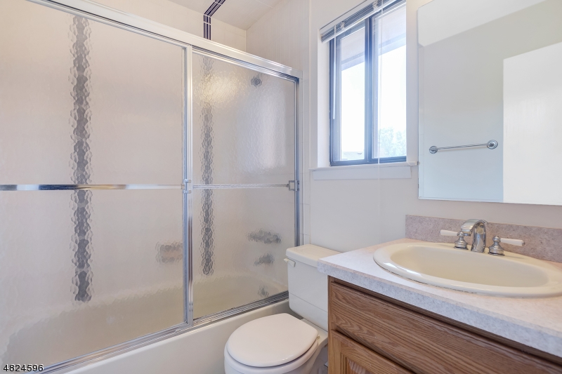 250 South Ridgedale Avenue, Unit 4 Florham Park, NJ 07932 - Photo 11 of 15 a bathroom with a sink toilet and shower
