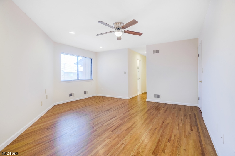 250 South Ridgedale Avenue, Unit 4 Florham Park, NJ 07932 - Photo 3 of 15 an empty room with wooden floor and windows
