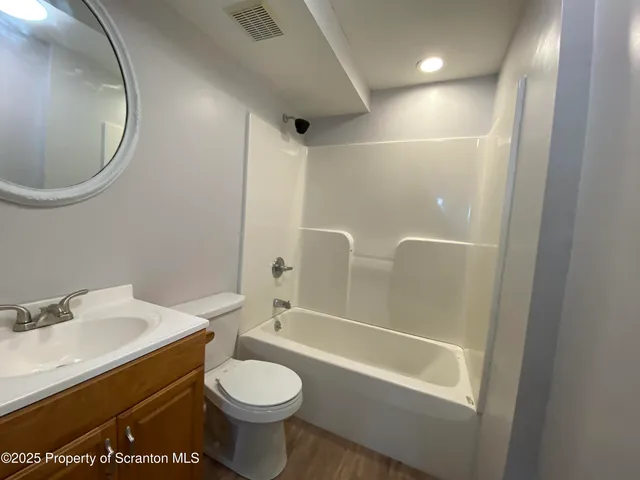 a kitchen with stainless steel appliances kitchen island granite countertop a refrigerator and a stove top oven