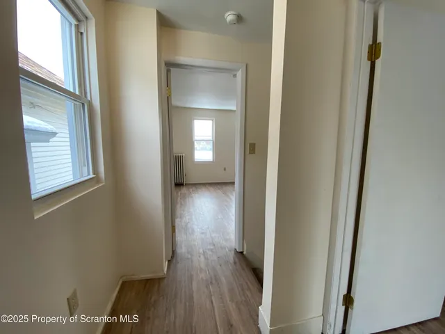 a kitchen with stainless steel appliances kitchen island granite countertop a table and chairs in it