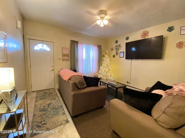 a living room with furniture kitchen and a window