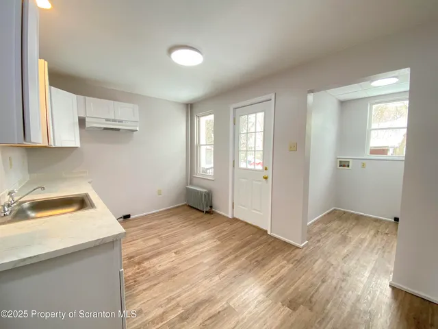 a view of a room with wooden floor