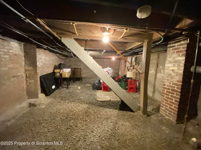 a view of a storage room with water heater and racks