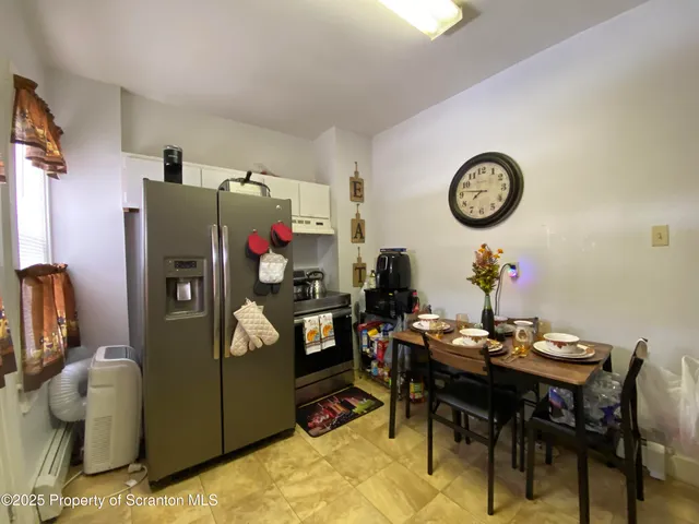 a view of a house with a patio and a yard