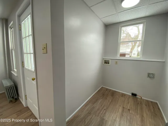 a view of hallway with wooden floor