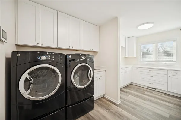 a utility room with sink dryer and washer