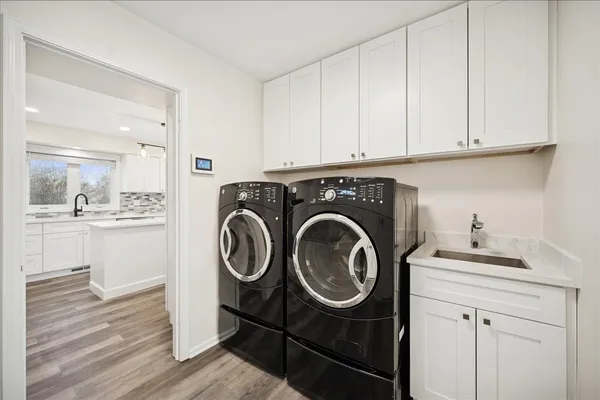 a utility room with sink dryer and washer