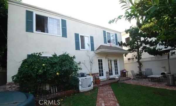 a front view of a house with garden and porch