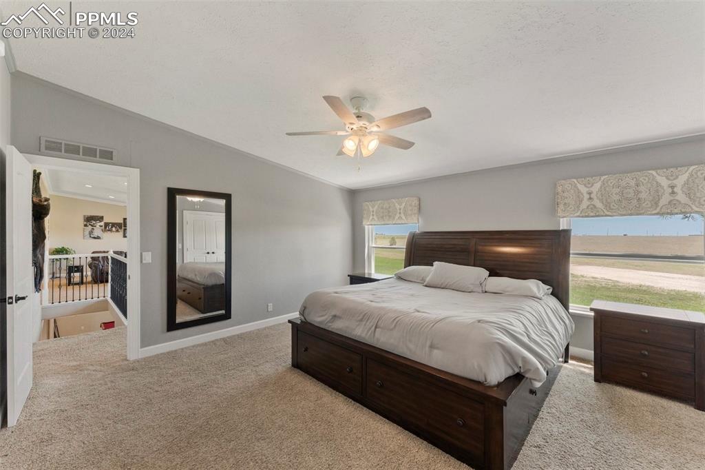 39245 Big Springs Road Rush, CO 80833 - Photo 10 of 30 a bedroom with a bed and a ceiling fan