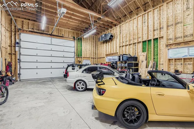 a view of a lake with table and chairs under an umbrella