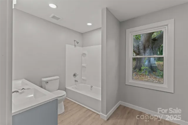 a view of bathroom with bathtub and toilet