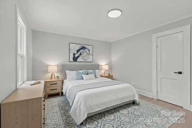 a bedroom with a bed and a painting on the wall