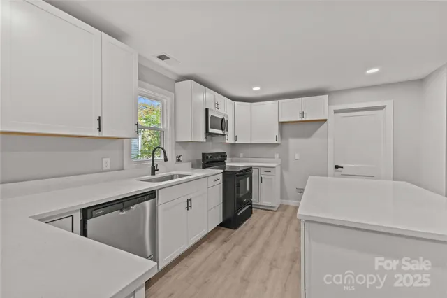 a kitchen with a sink a stove and cabinets