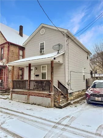 a view of a house with a wooden deck