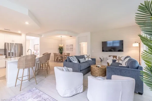 a bedroom with a bed and a flat tv screen on dresser
