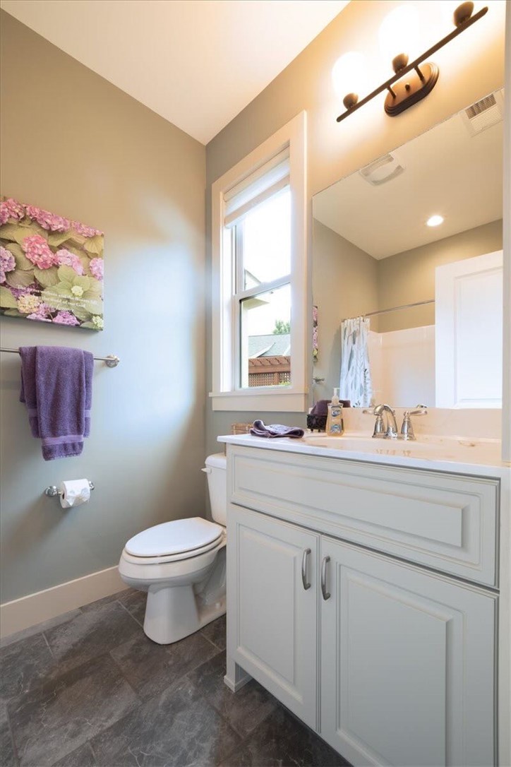 217 Pershing Avenue Clemson, SC 29631 - Photo 18 of 37 Well-appointed bathroom showcasing a clean white vanity, a large mirror, and ample natural light from the window.