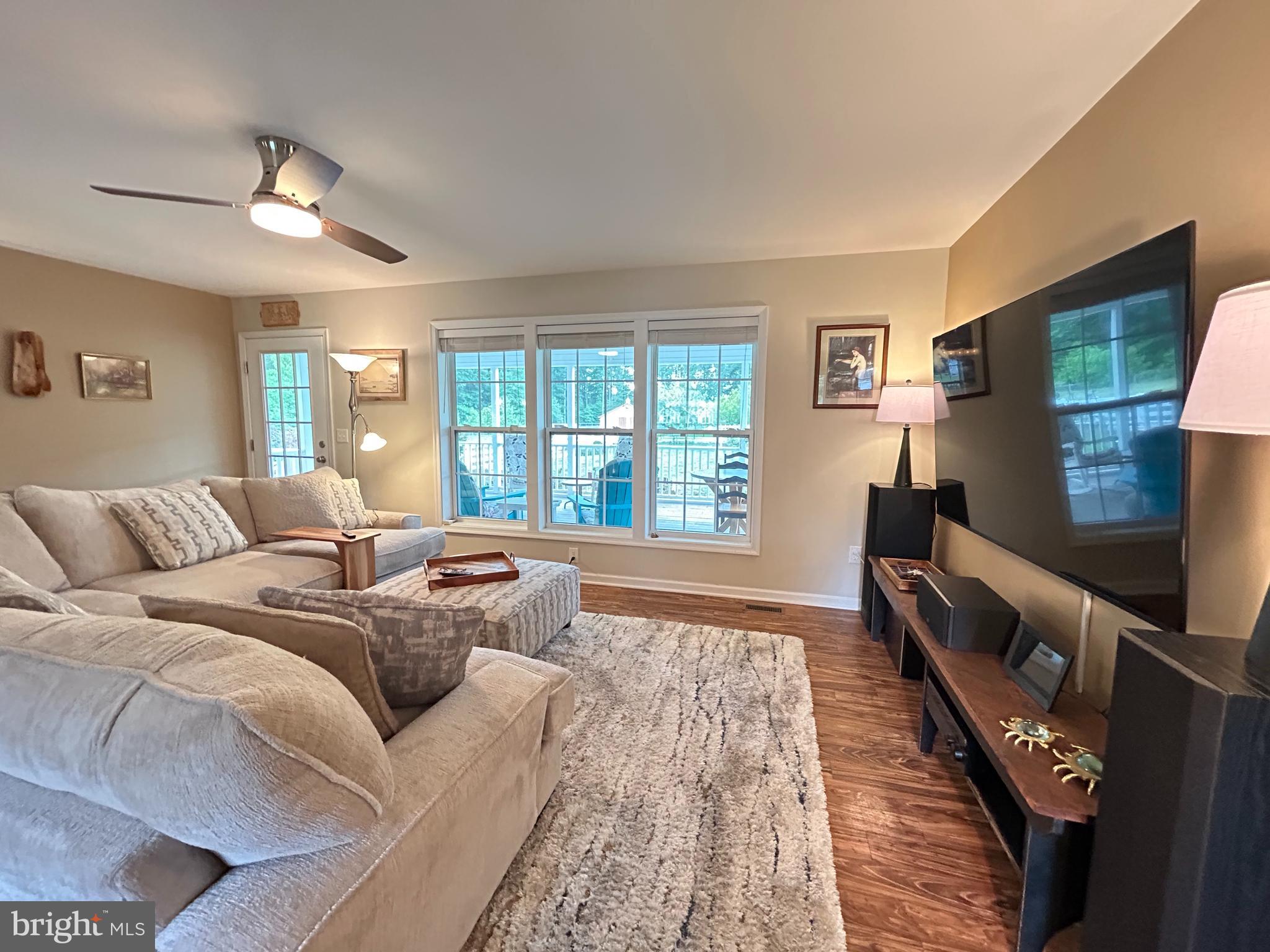 20346 Cool Spring Road Milton, DE 19968 - Photo 21 of 67 a living room with furniture and a flat screen tv