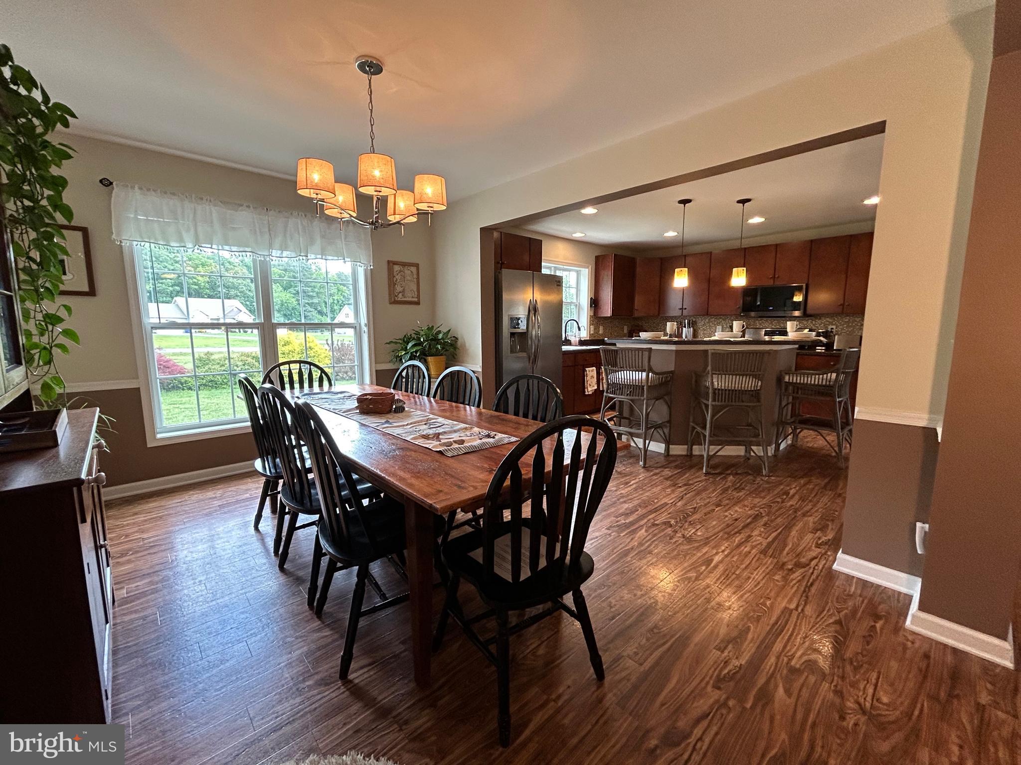20346 Cool Spring Road Milton, DE 19968 - Photo 23 of 67 a view of a dining room with furniture wooden floor and chandelier