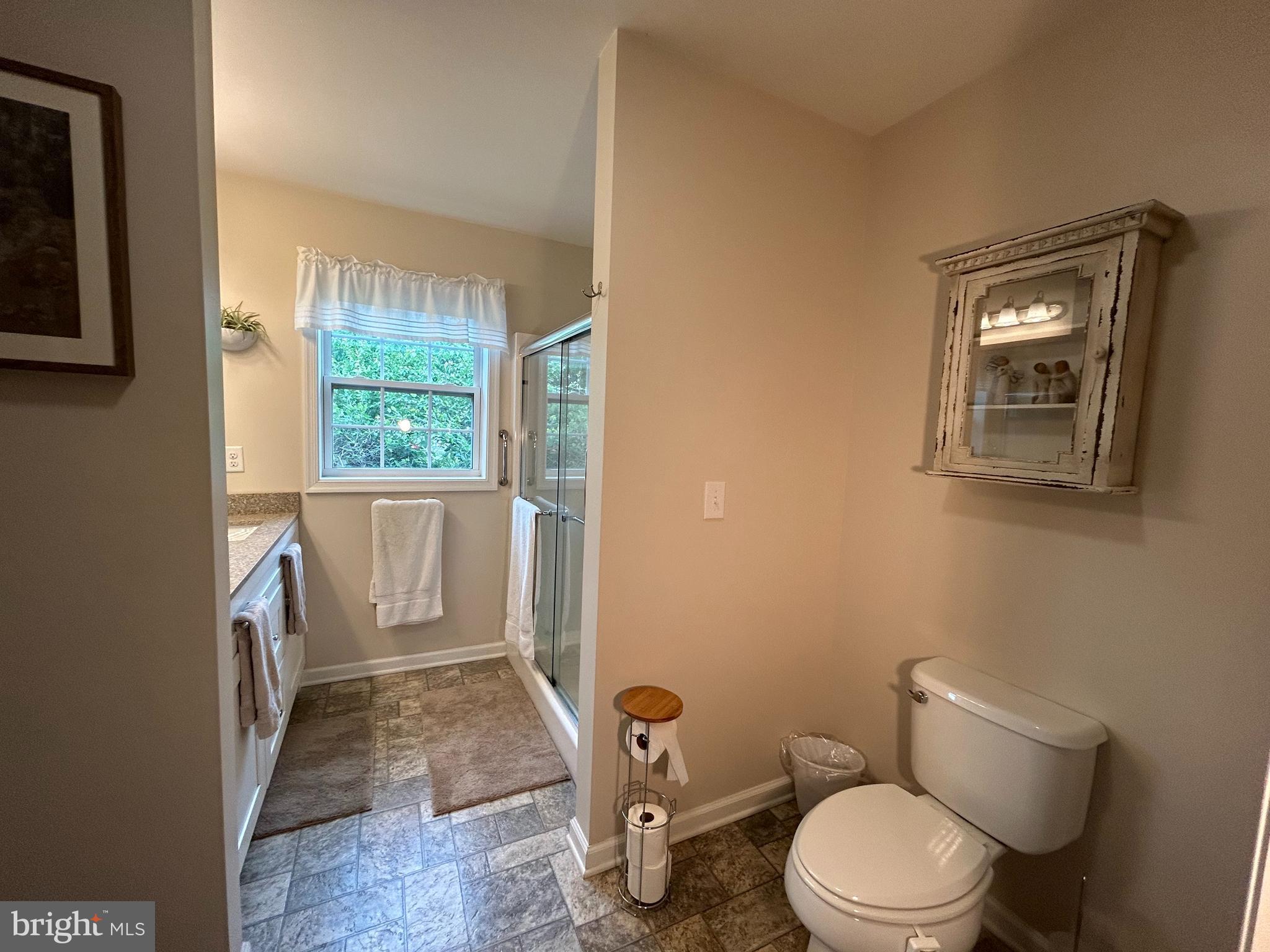 20346 Cool Spring Road Milton, DE 19968 - Photo 38 of 67 a white toilet sitting next to a window in a bathroom